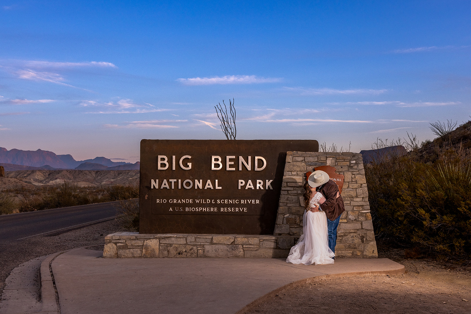 Just Married Kiss at Big Bend Caitlin and Michael sharing a just married kiss at the entrance to Big Bend National Park during sunset going into blue hour.