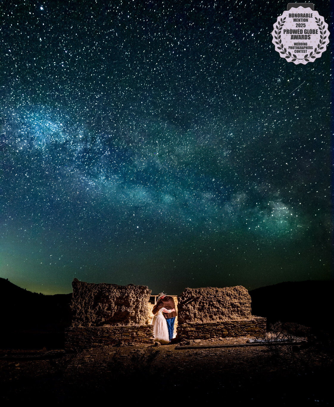 2025 ProWed Global Award Honorable Mention Photo of a bride and groom embracing beneath the Milky Way during a nighttime wedding portrait in Terlingua, Texas
